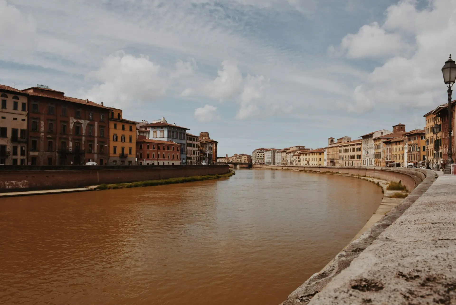 a river running through a city next to tall buildings